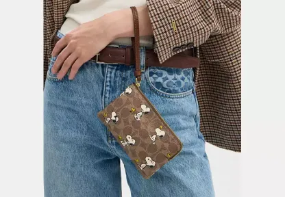 Coach X Peanuts Corner Zip Wristlet In Signature Canvas With Snoopy Print