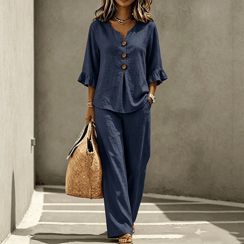 A women's set consisting of a ruffled sleeve top and wide-leg trousers.