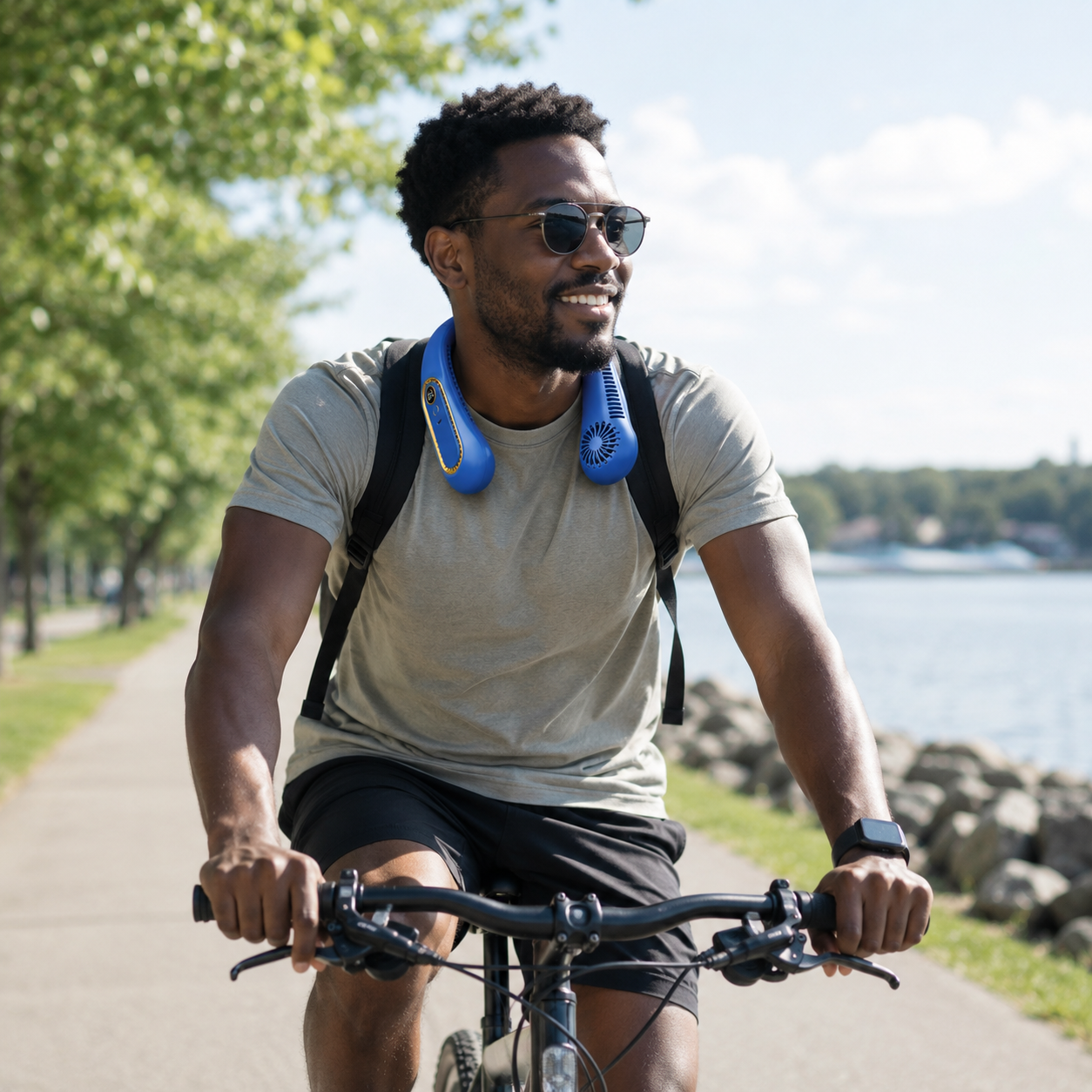 Cyclist wearing a blue cooling neck fan