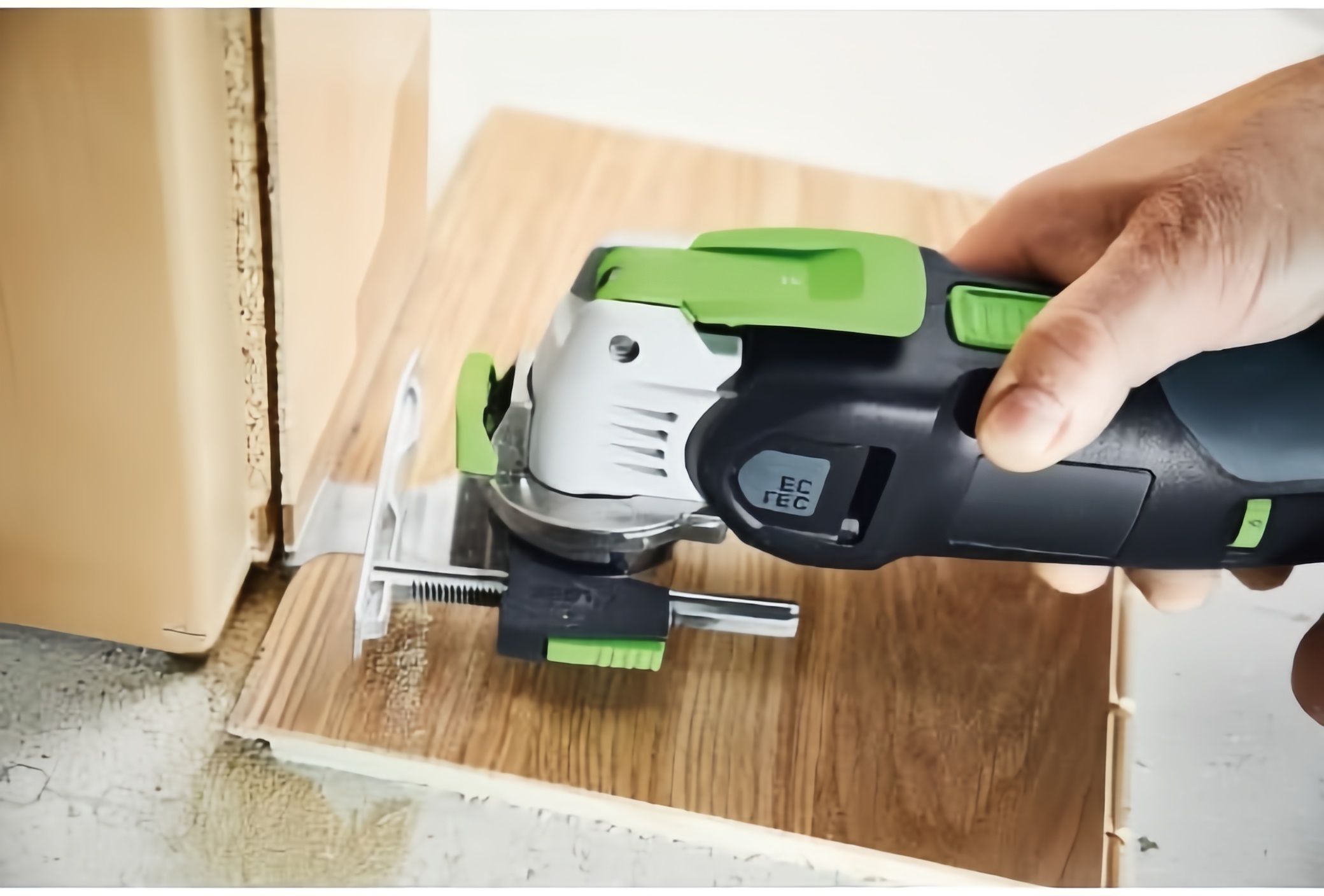 Oscillating multi-tool with plunge base cutting flooring