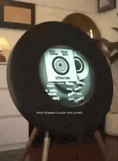 Round speaker with clock display glowing in a cozy room