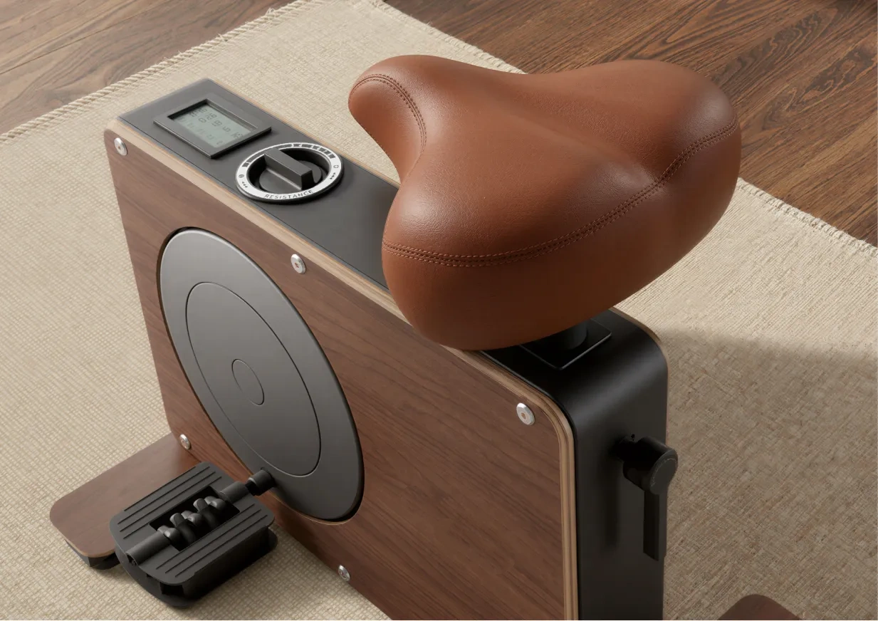 Close-up of the exercise bike seat, resistance dial, and display