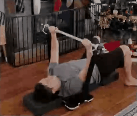 Athlete using the modular bench training pad for floor bench press