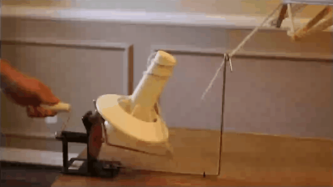 Metal yarn ball winder in action rolling yarn into a center-pull ball