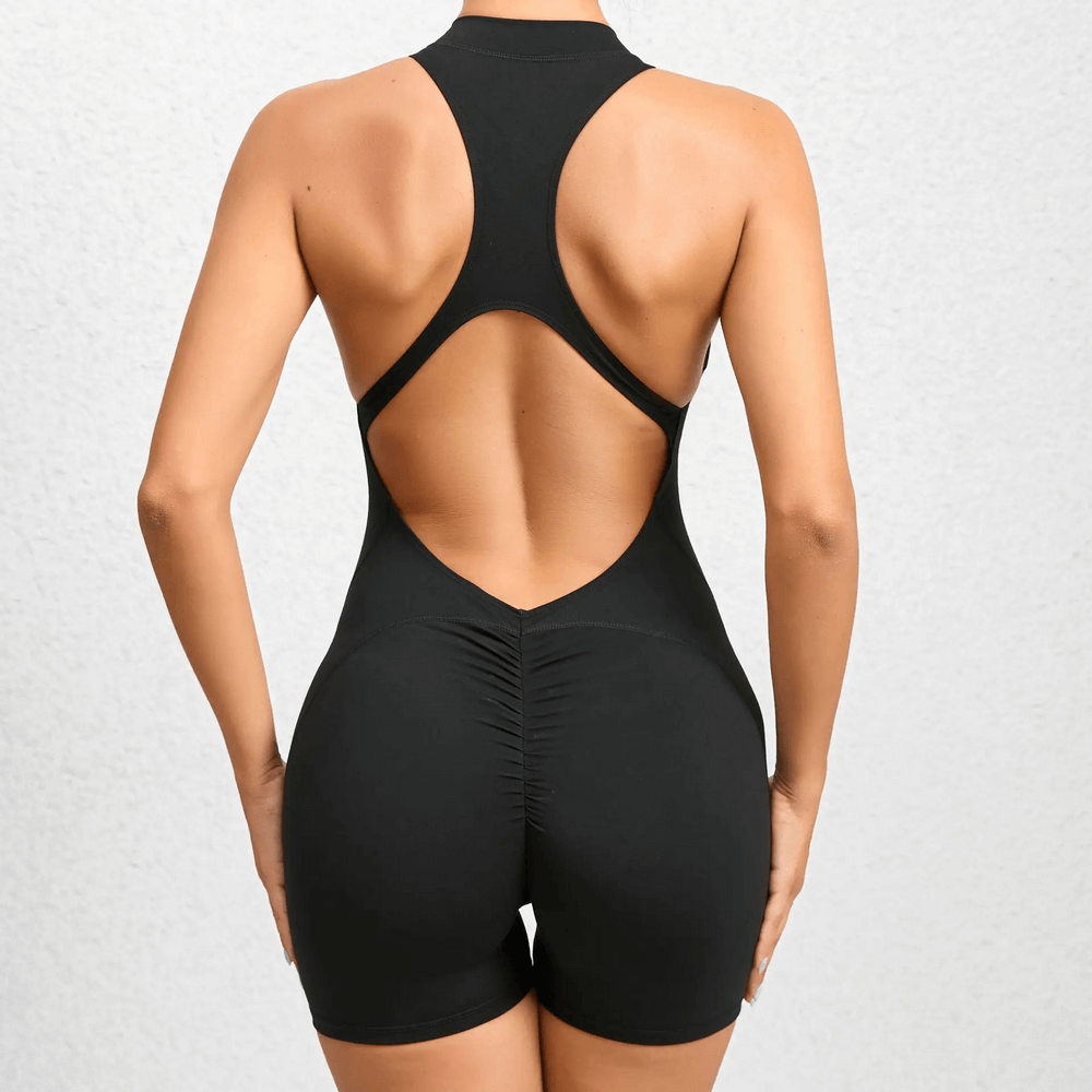 Women's sleeveless short gym jumpsuit with racerback open back design for yoga workout and fitness training sessions.