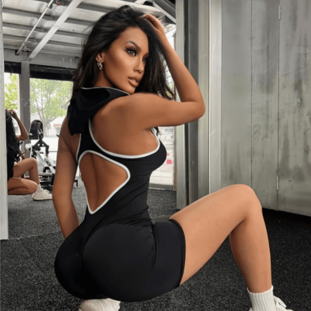 Women's seamless hooded yoga jumpsuit with open back design short fitness romper for gym training sportswear.
