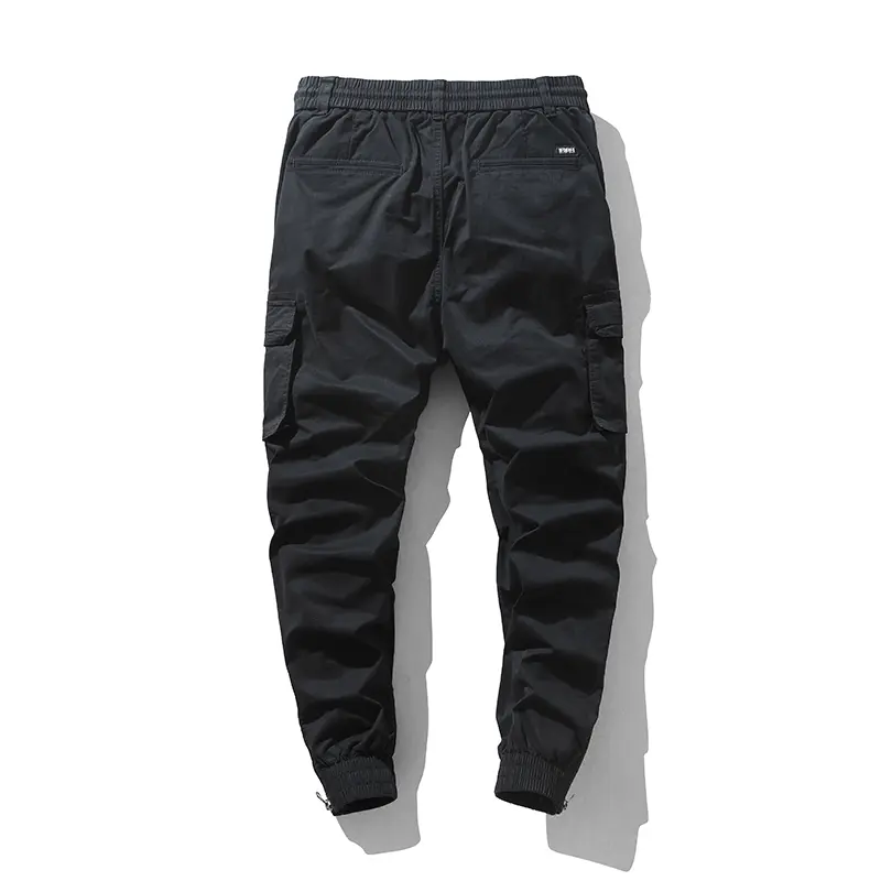 Stylish solid-color cargo pants featuring an elastic drawstring design, multiple pockets, and multiple flap details