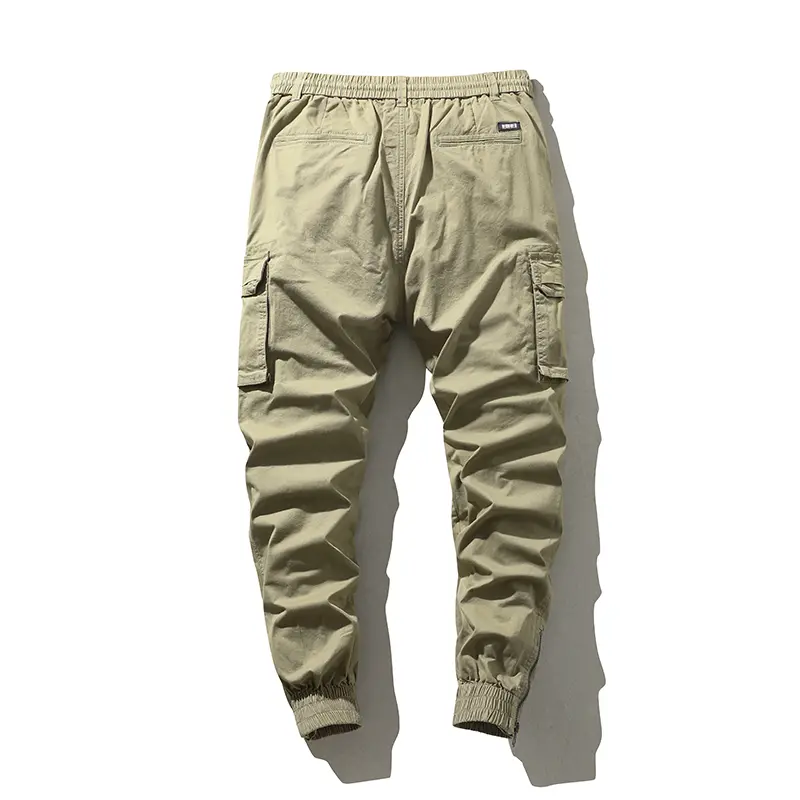 Stylish solid-color cargo pants featuring an elastic drawstring design, multiple pockets, and multiple flap details