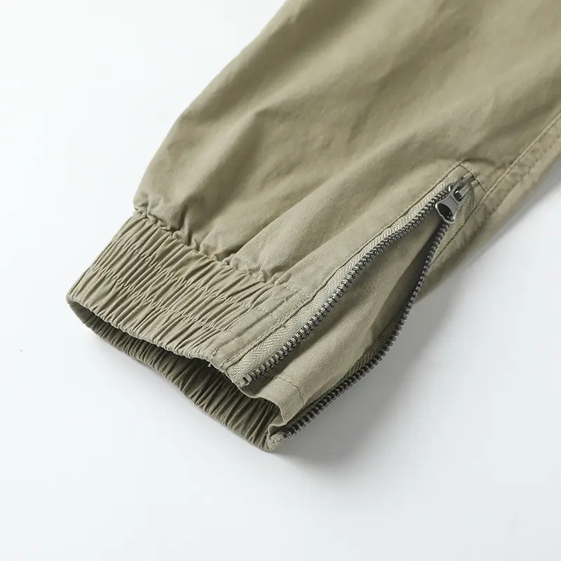 Stylish solid-color cargo pants featuring an elastic drawstring design, multiple pockets, and multiple flap details