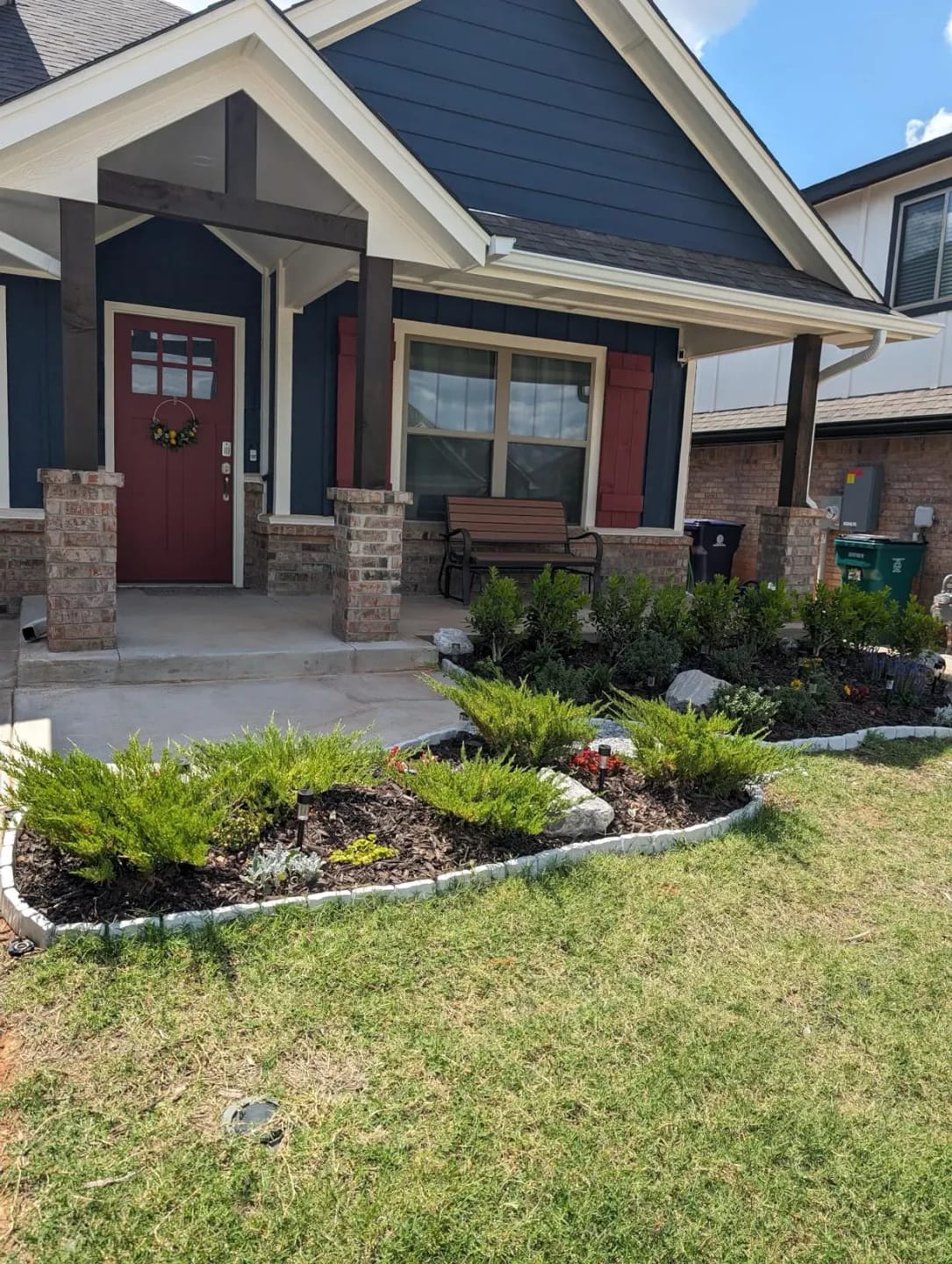 Customer's light gray Faux Stone Garden Edging Border installed around a front yard garden bed.
