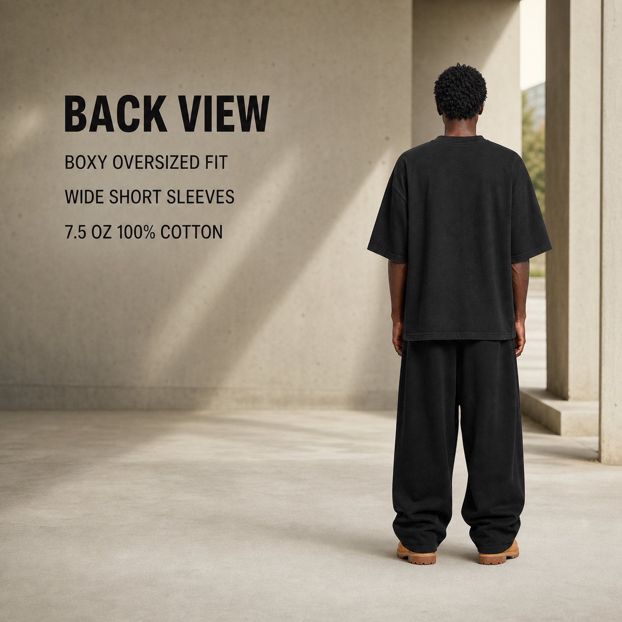 Back view showing the boxy oversized fit and wide short sleeves