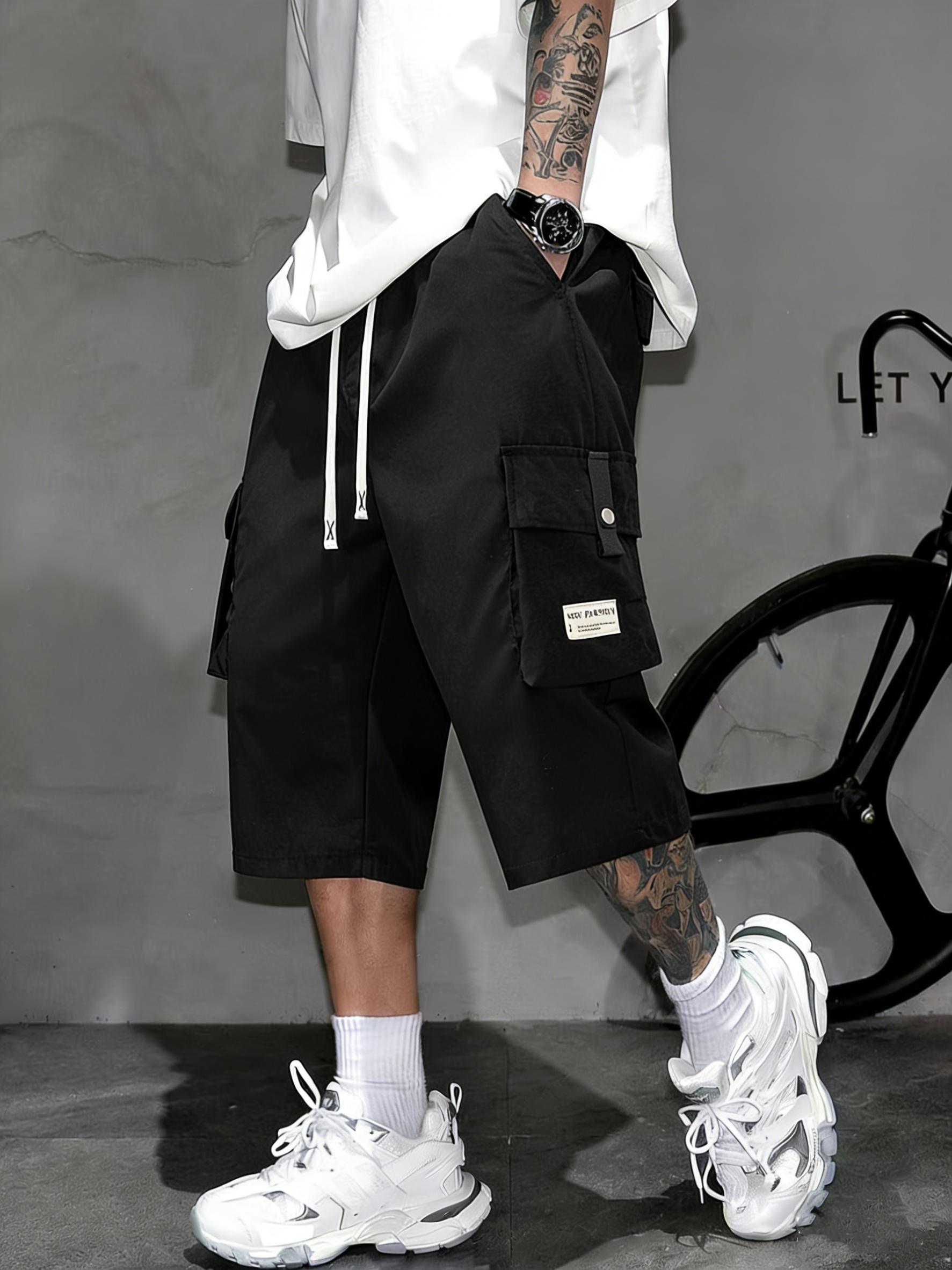 Men’s cargo shorts—knee-length tactical work shorts with multiple pockets and a street-style casual design for summer. Features an elastic waistband with drawstring, pocket patch appliqué design, and is very comfortable to wear.