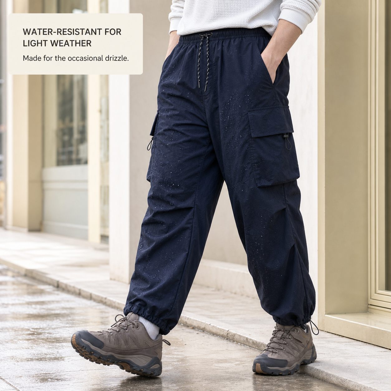 Navy parachute cargo pants in a natural light drizzle