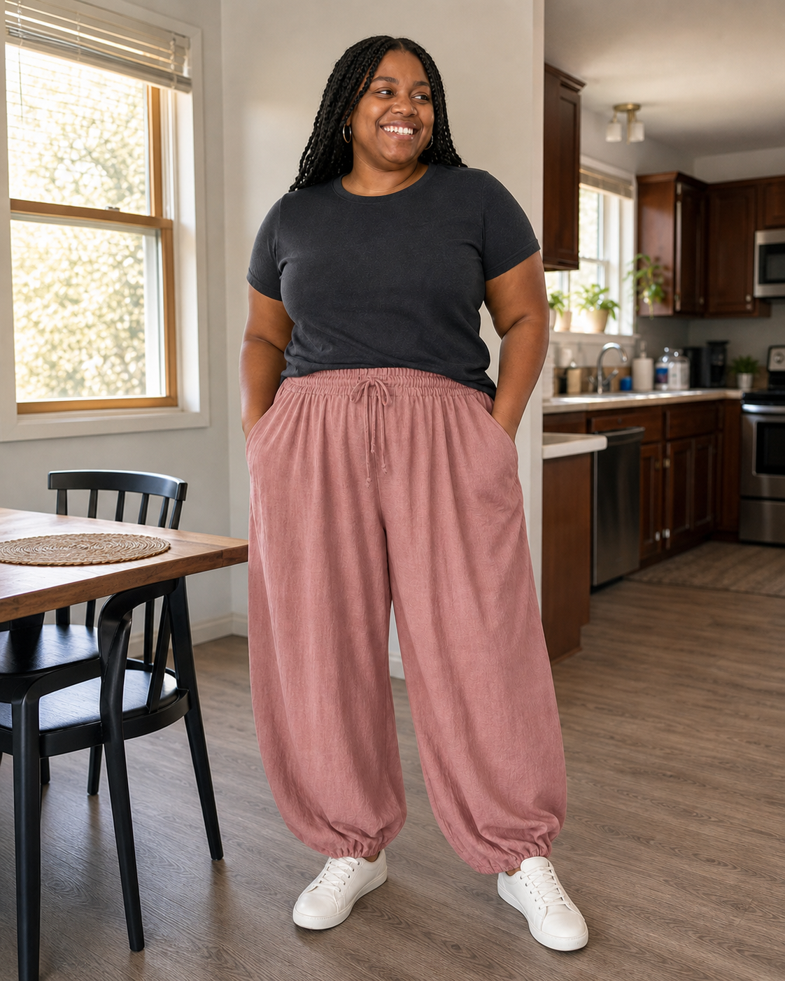 Plus-size model wearing dusty-rose linen-blend wide-leg palazzo pants in a sunlit home kitchen