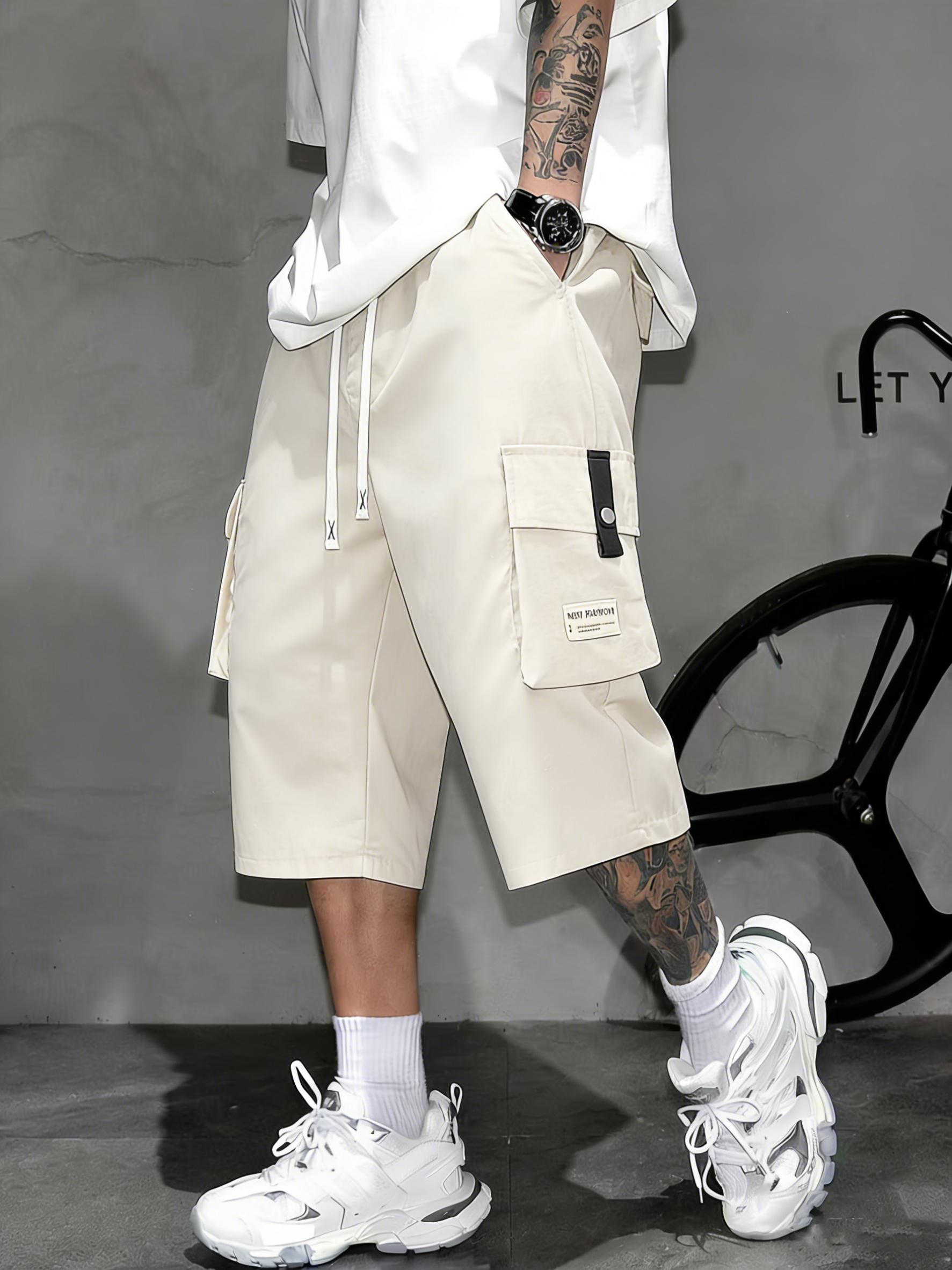 Men’s cargo shorts—knee-length tactical work shorts with multiple pockets and a street-style casual design for summer. Features an elastic waistband with drawstring, pocket patch appliqué design, and is very comfortable to wear.