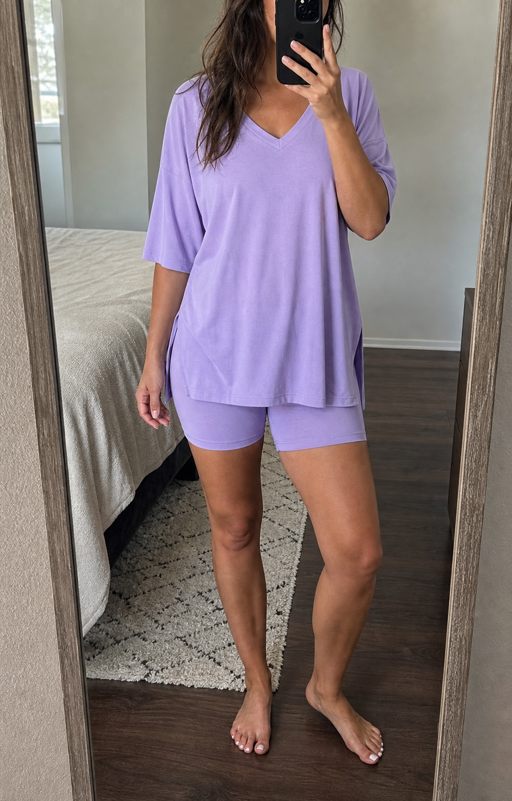 Midsize model wearing the lavender V-neck tee and biker shorts set