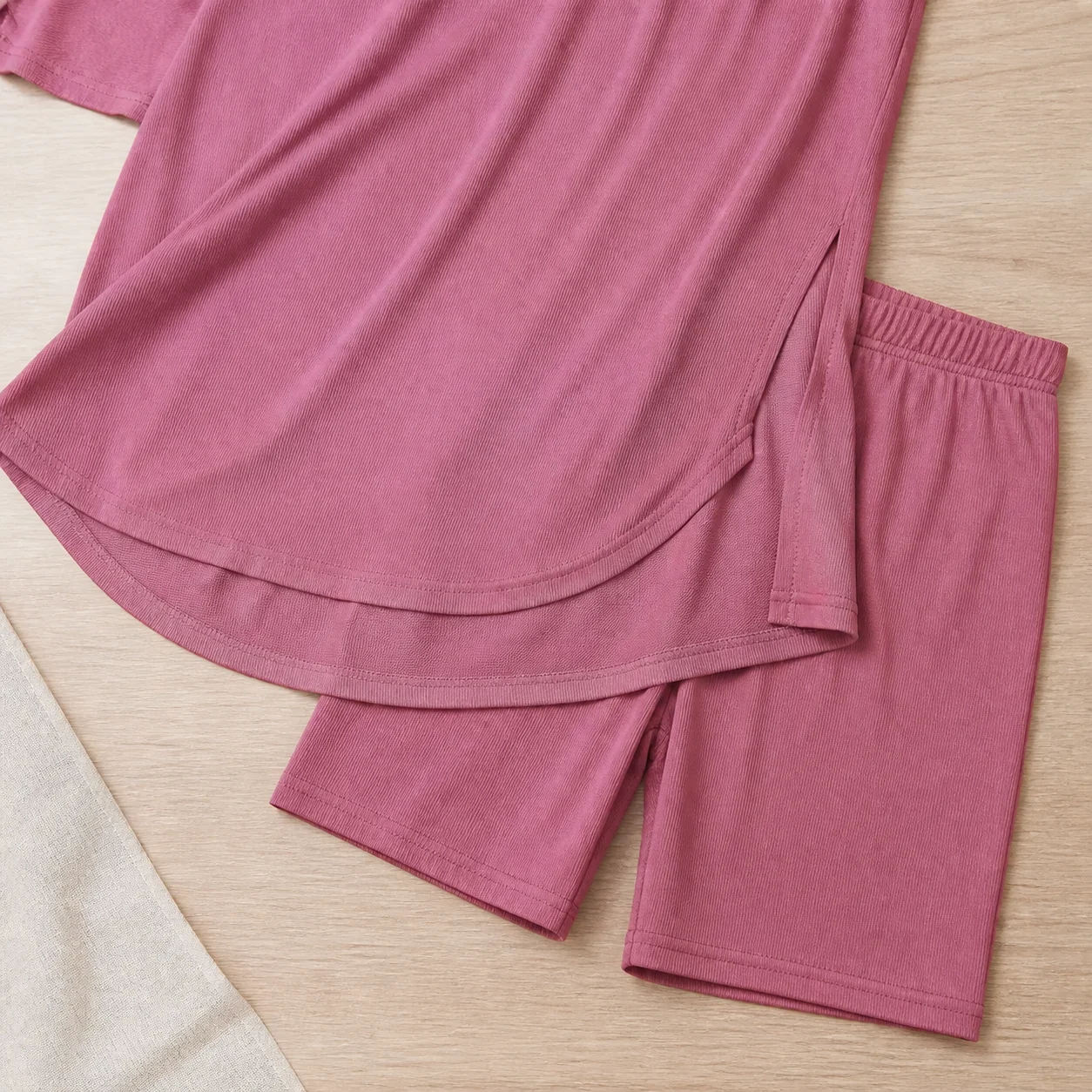 Close view of side slit high-low hem and matching biker shorts
