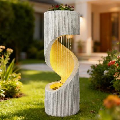 Fuente moderna con cascada de columna en espiral e iluminación LED para la decoración de jardines y patios.