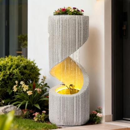 Fuente moderna con cascada de columna en espiral e iluminación LED para la decoración de jardines y patios.