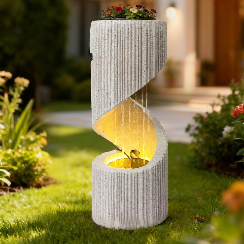 Fuente moderna con cascada de columna en espiral e iluminación LED para la decoración de jardines y patios.