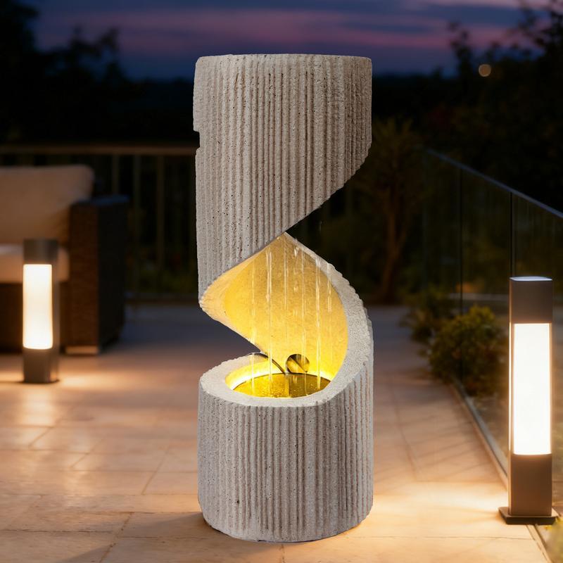 Fuente moderna con cascada de columna en espiral e iluminación LED para la decoración de jardines y patios.