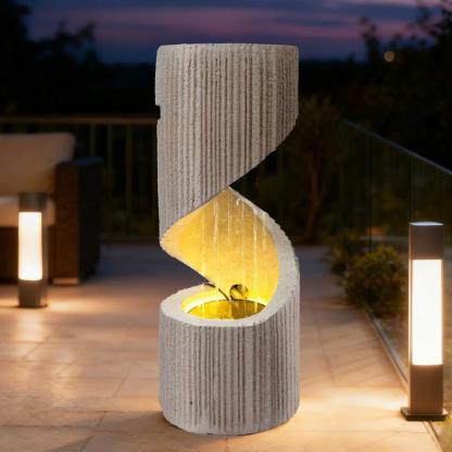 Fuente moderna con cascada de columna en espiral e iluminación LED para la decoración de jardines y patios.