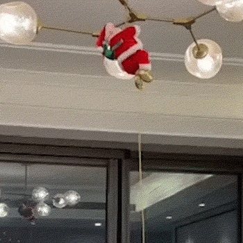 Climbing Santa brings a Christmas tree to life