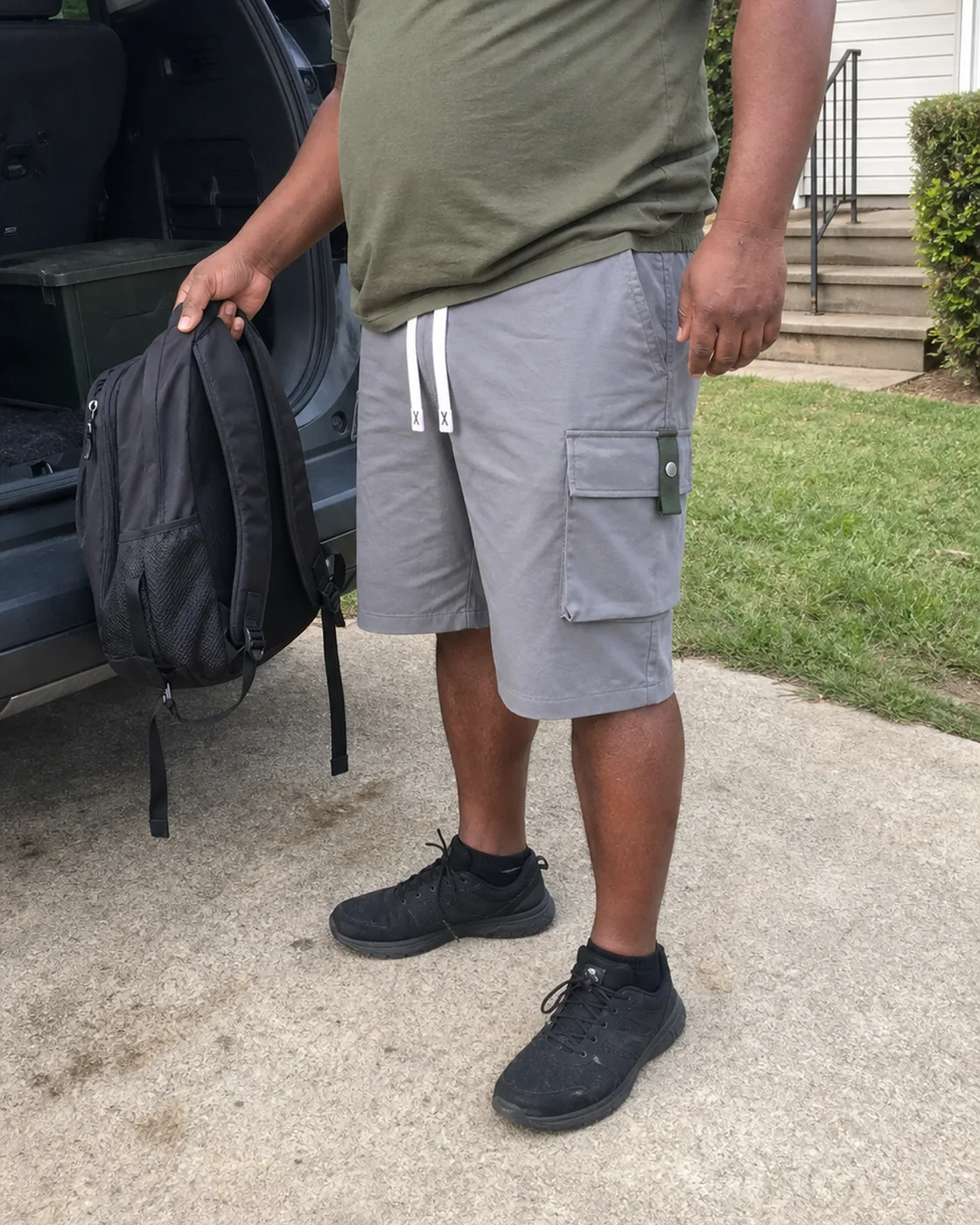 Gray plus-size cargo shorts driveway backpack photo
