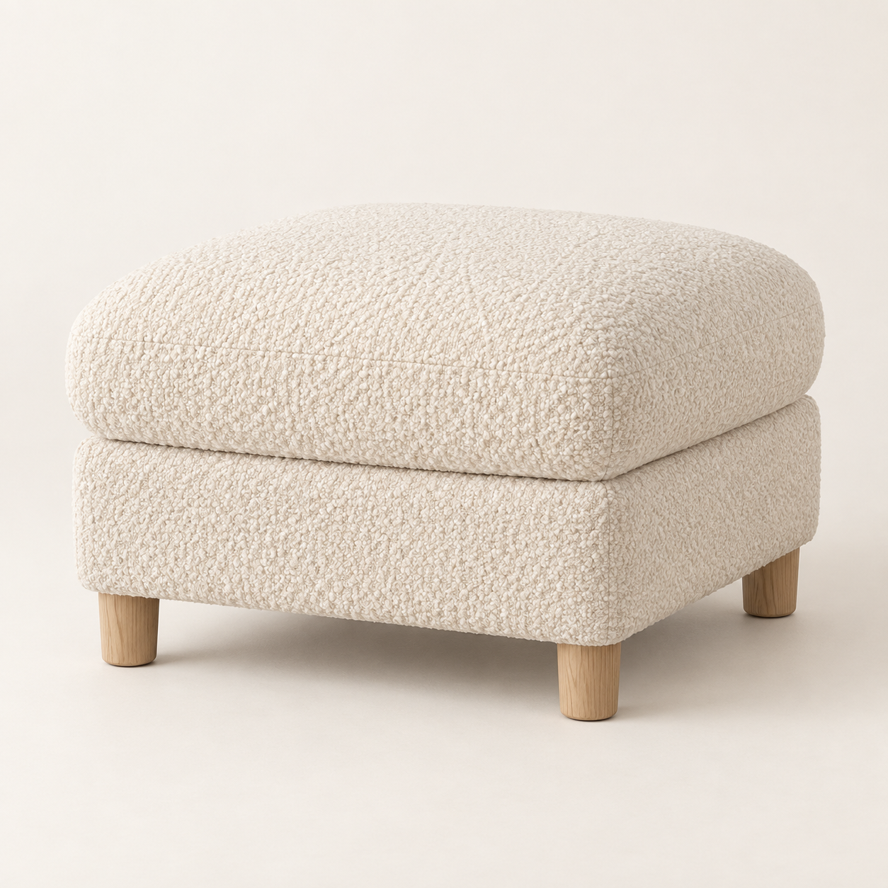 Cloud Bouclé Ottoman on a warm neutral background