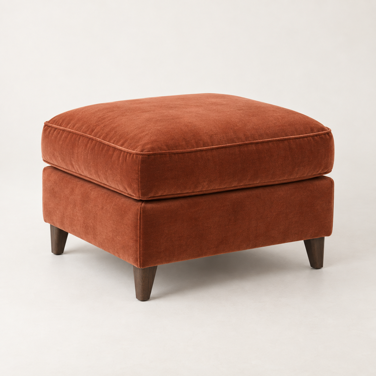 Ember Velvet Ottoman on a warm neutral background