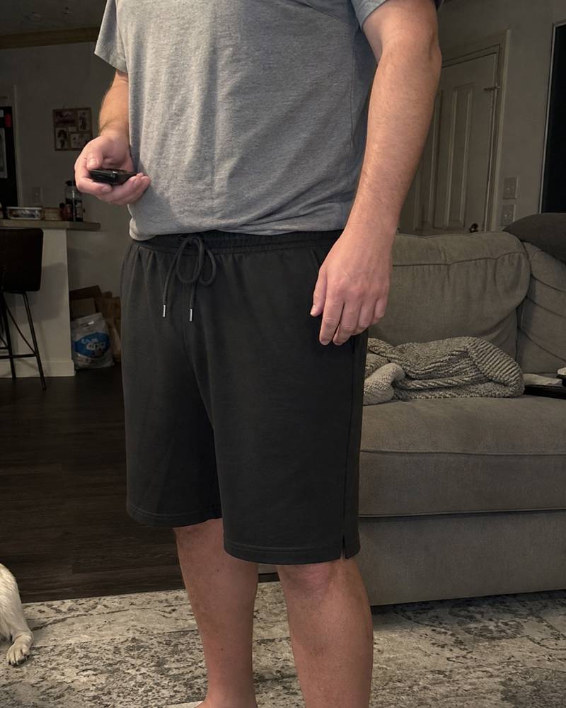 Black cotton jersey lounge shorts photographed in a living room