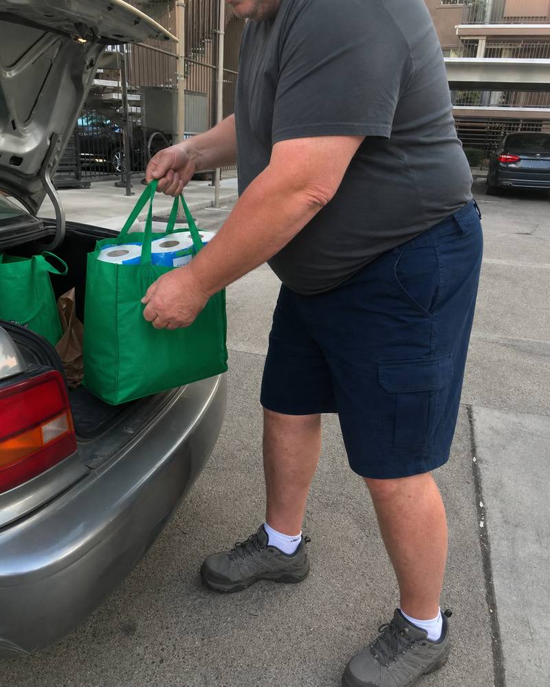Big and tall stretch twill cargo shorts photographed beside an open car trunk