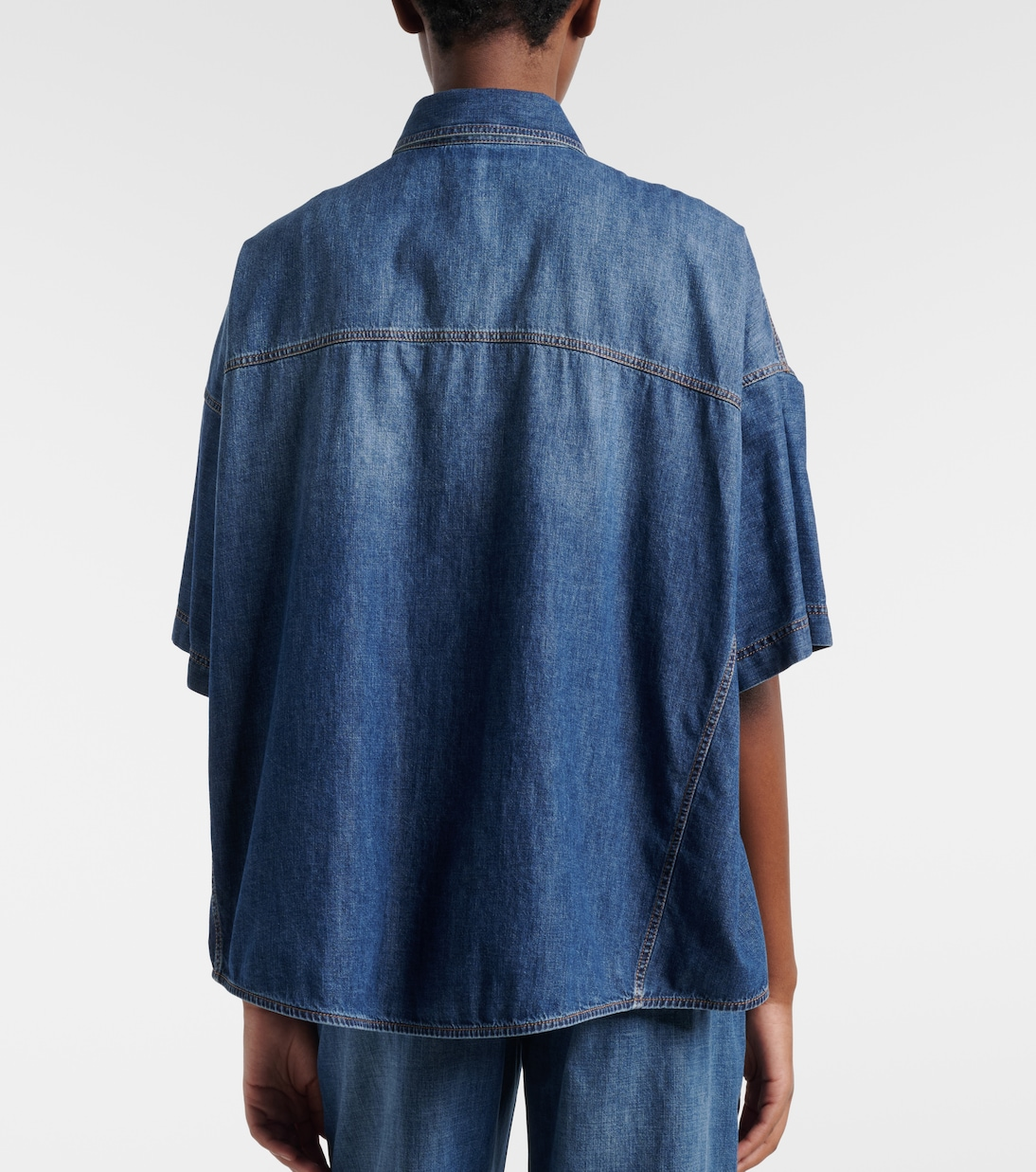 Back view of oversized short sleeve denim shirt