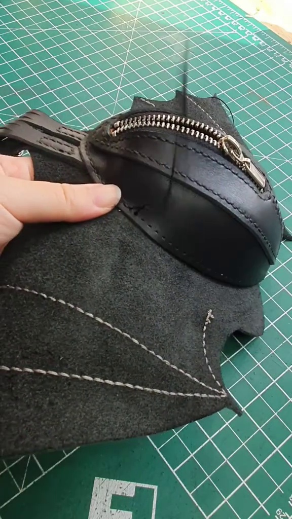 Secure zip pocket being assembled into the leather bat body