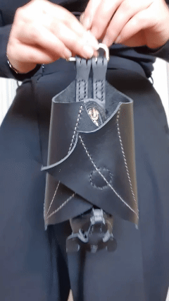Animated product GIF showing the leather bat coin purse opening from folded wings to full bat shape