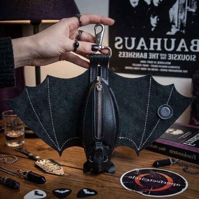 Finished leather bat coin purse detail showing the structured wings, stitching, clip, and carry-ready form