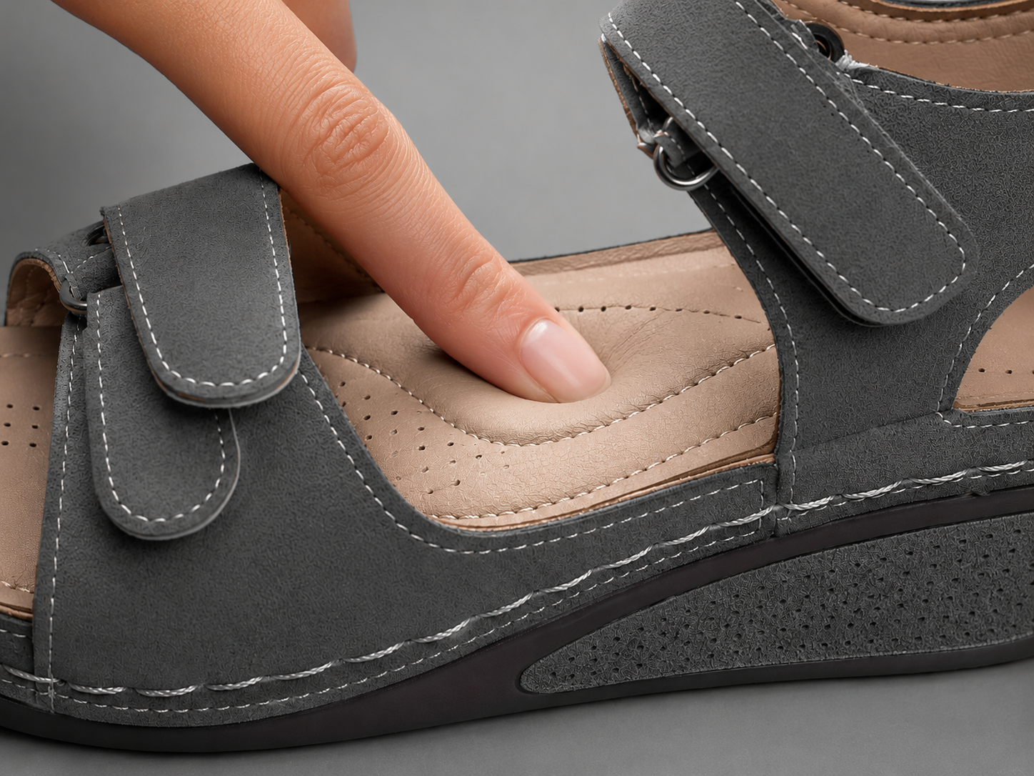 Suggested image: close-up of hand pressing the sandal footbed to show soft cushioning and rebound
