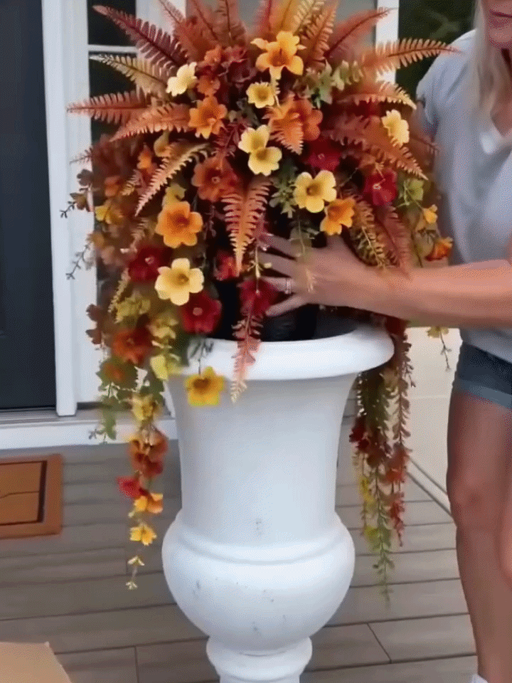 Main product photo of the Fauxely artificial fall harvest hanging basket with orange, yellow, and warm red flowers