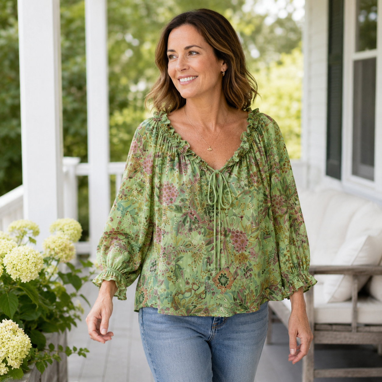 Woman wearing green floral blouse on a porch lifestyle scene