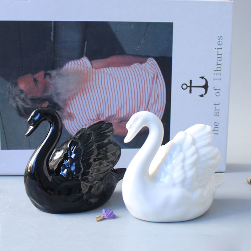 Modern minimalist black and white swan ceramic figurines for couples, a wedding gift, home decor, and wedding room decoration.