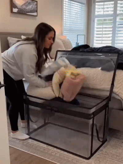 Suggested image: happy homeowner holding or organizing VAYRLO 29L clear storage bags in a tidy bedroom closet