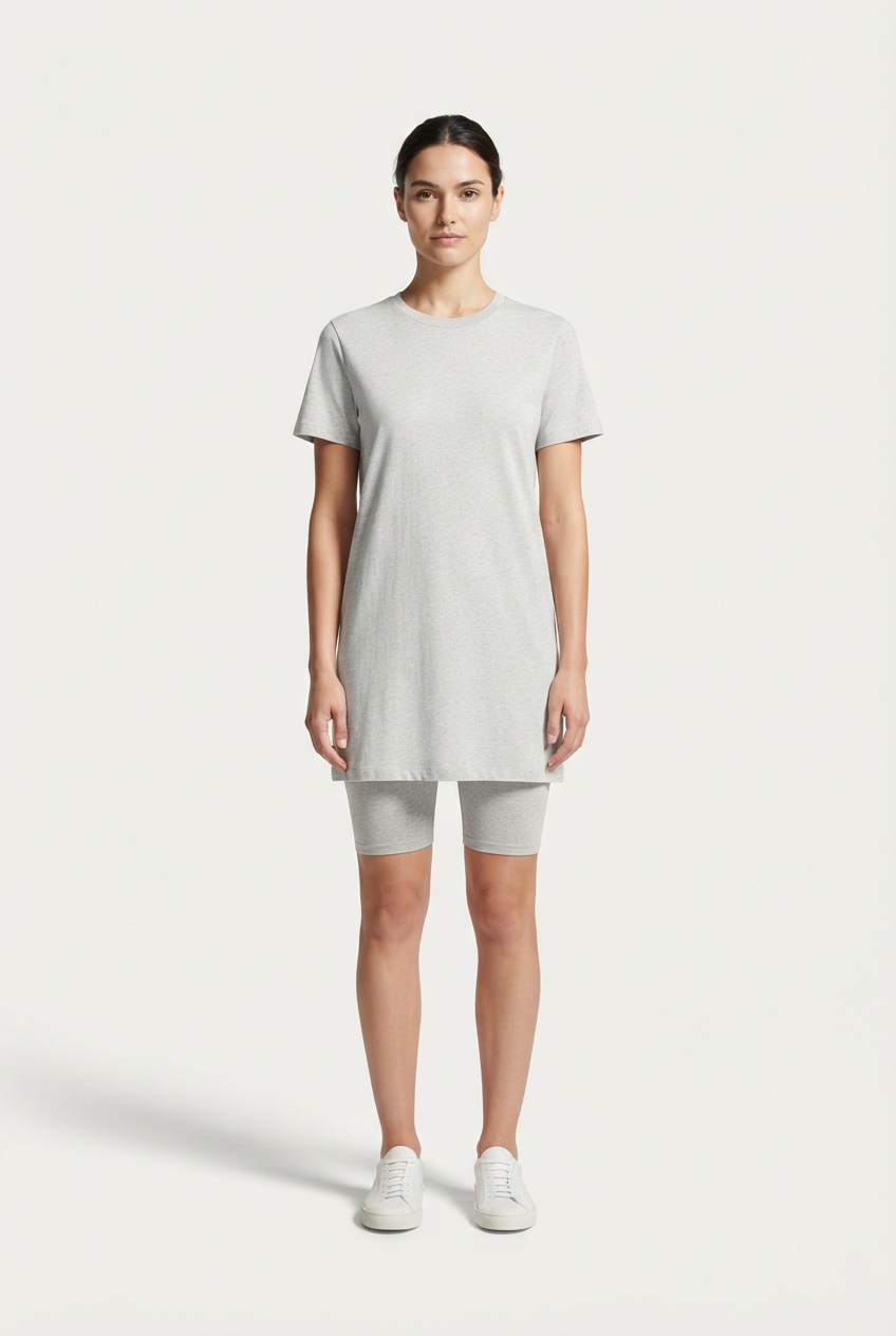 Model wearing a lightgrey minimalist short-sleeve cotton dress against an off-white studio background