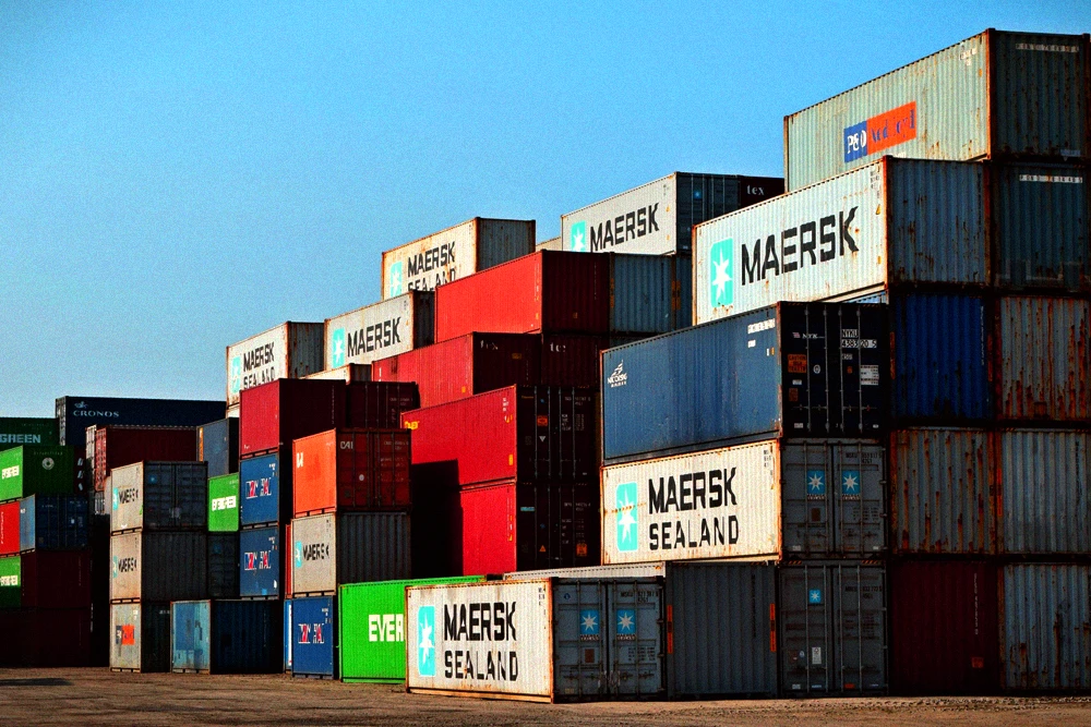 Shipping containers at a port representing refrigerant import and distribution costs