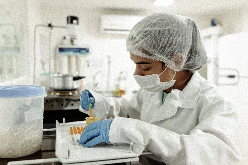 Laboratory professional testing samples to verify reclaimed refrigerant purity