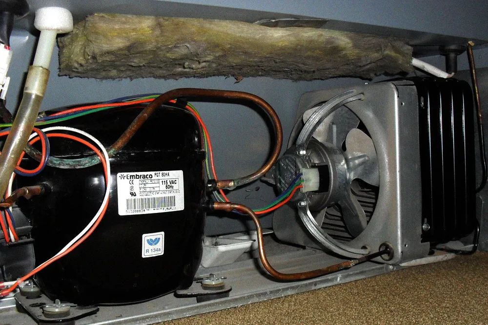 Refrigeration compressor connected to a metal condenser coil