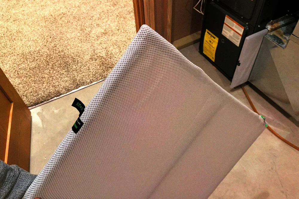 Reusable pleated HVAC air filter removed for inspection