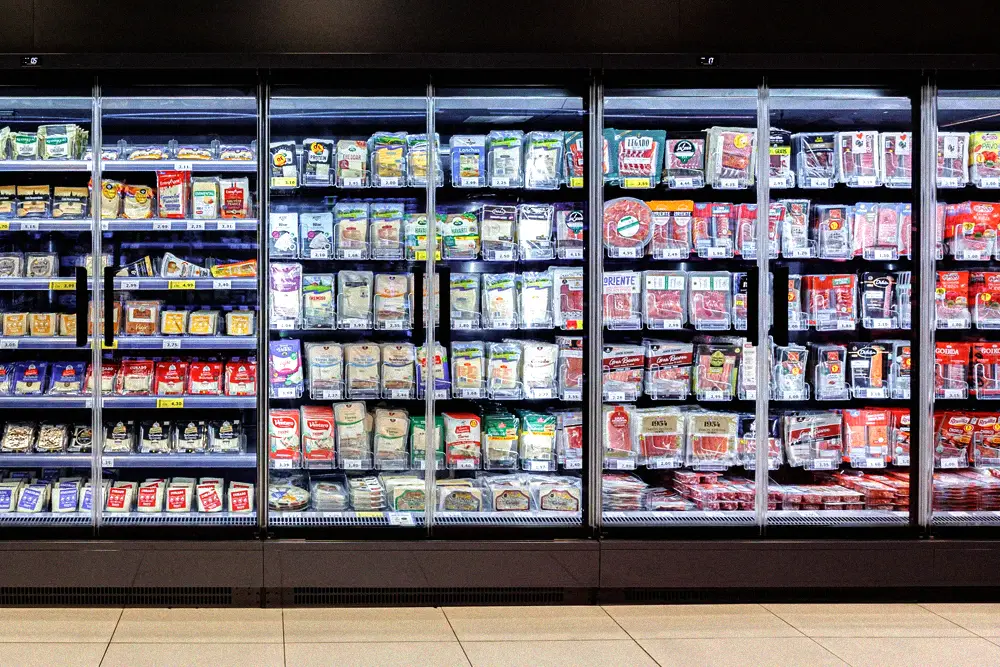 Refrigerated display cases in a modern supermarket aisle