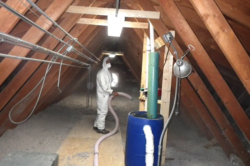 Cellulose insulation being installed across a residential attic