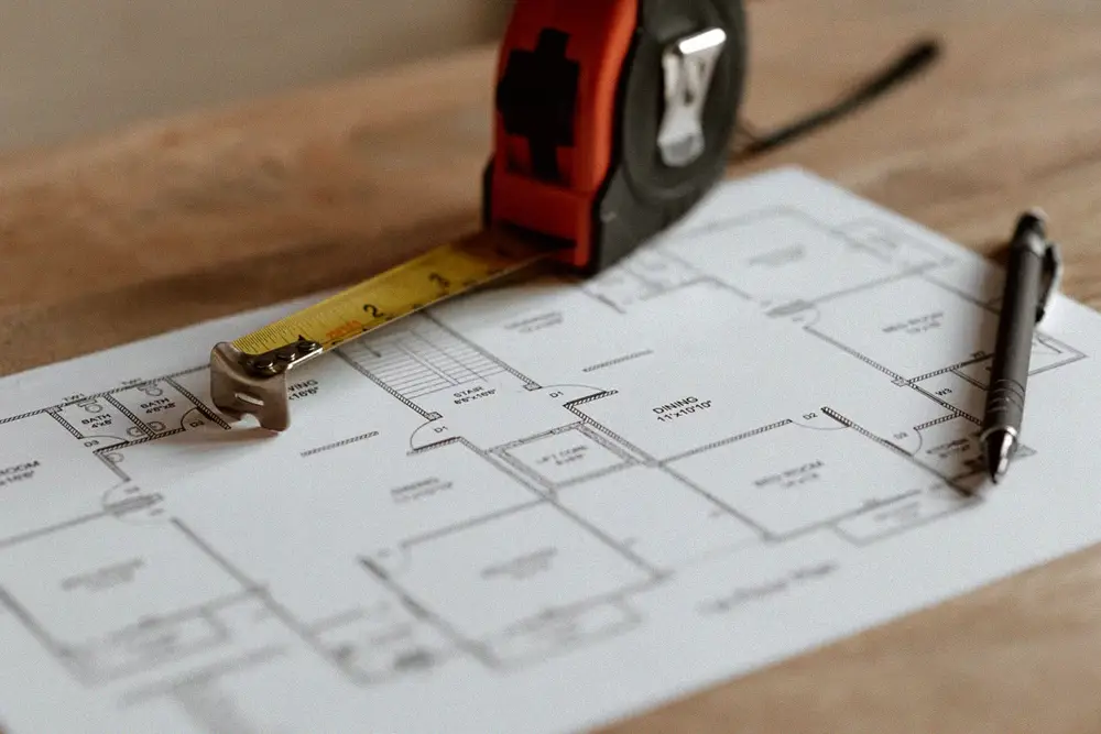 Measuring tape and technical plans used to verify R410A replacement coil dimensions and compatibility