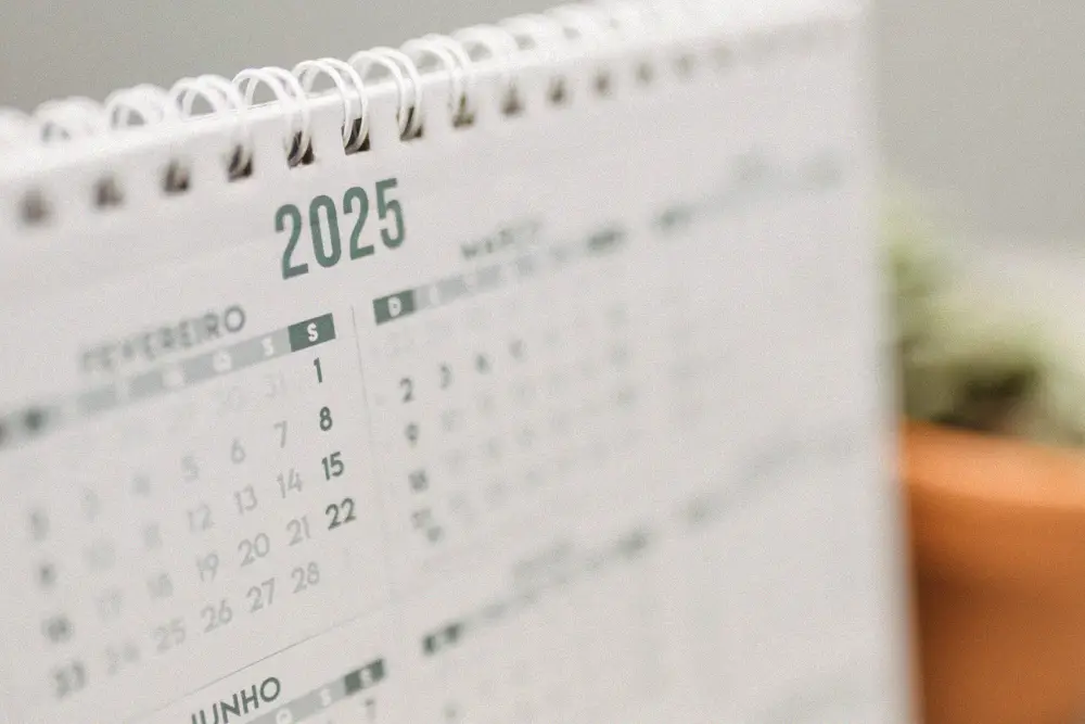 A 2025 desk calendar representing the transition between older and newer air-conditioning refrigerants.